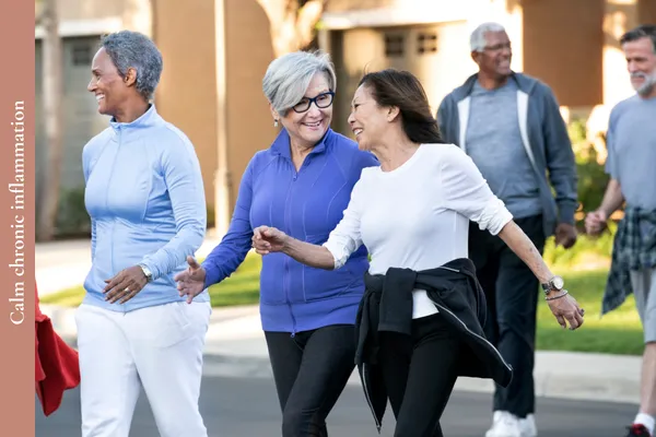 Men and women in midlife walking outdoors to reduce inflammation and support health