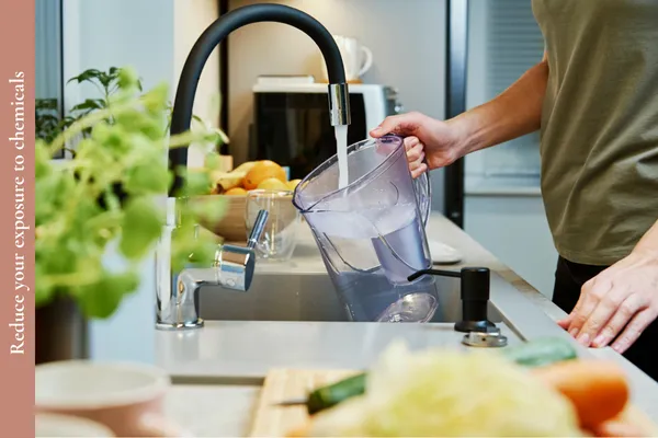 Man refilling a water filter jug to reduce lead exposure