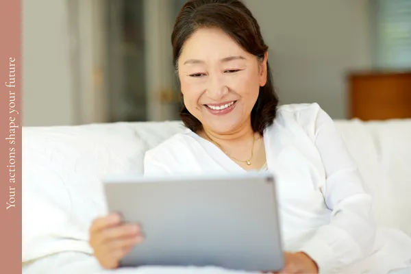 Woman in midlife using a brain training app on her tablet to improve memory and focus.