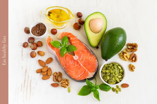 A selection of healthy fats from salmon, avocado, olive oil, nuts and seeds to support brain health and weight loss.