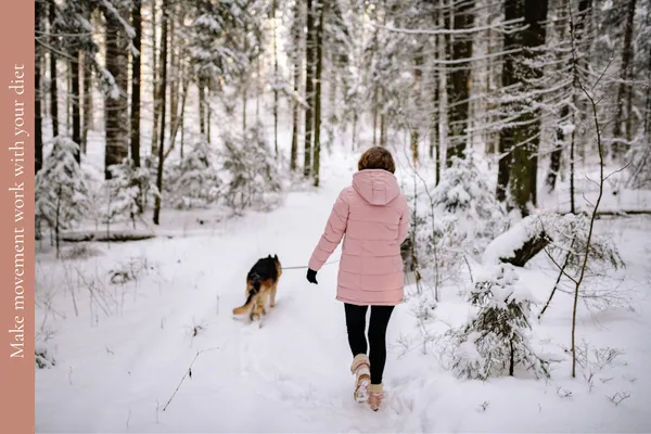 Woman in her 50s walking her dog in winter to help manage her weight alongside what she eats.