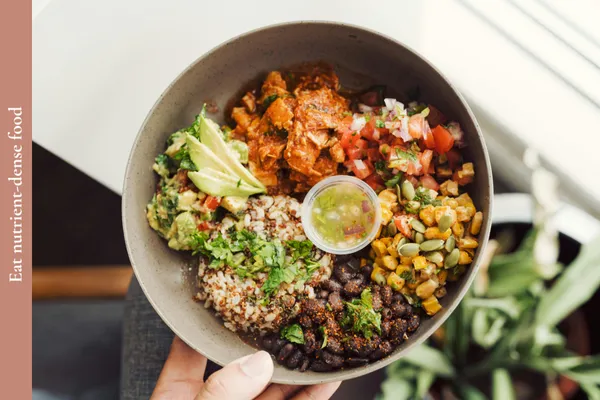 A bowl of nutrient-dense food including salmon, rice, beans and vegetables for a healthy brain