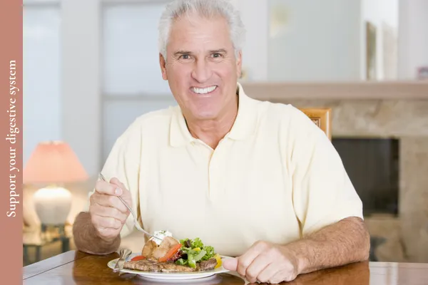 Man in midlife eating a healthy meal slowly to support digestion and reduce heartburn.