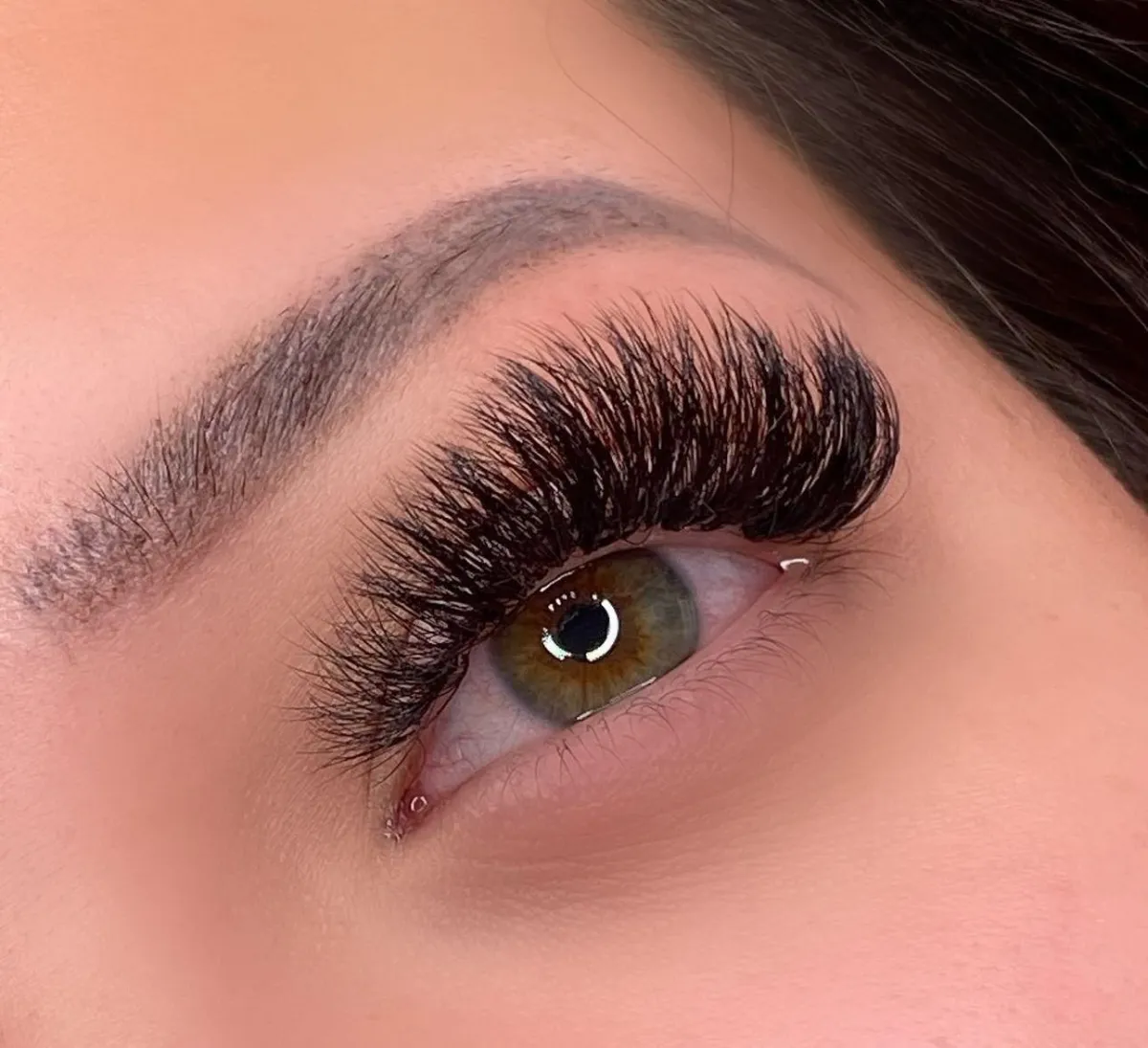 "Lash tech in Calgary applying mega volume set"