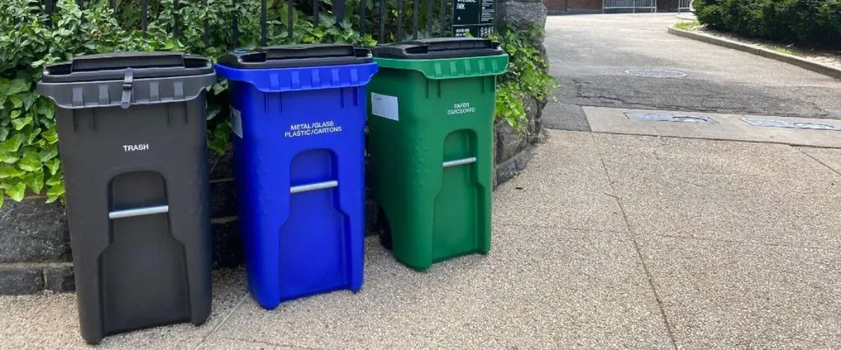 Residential trash cans and recycling bins lined up curbside in Kansas City