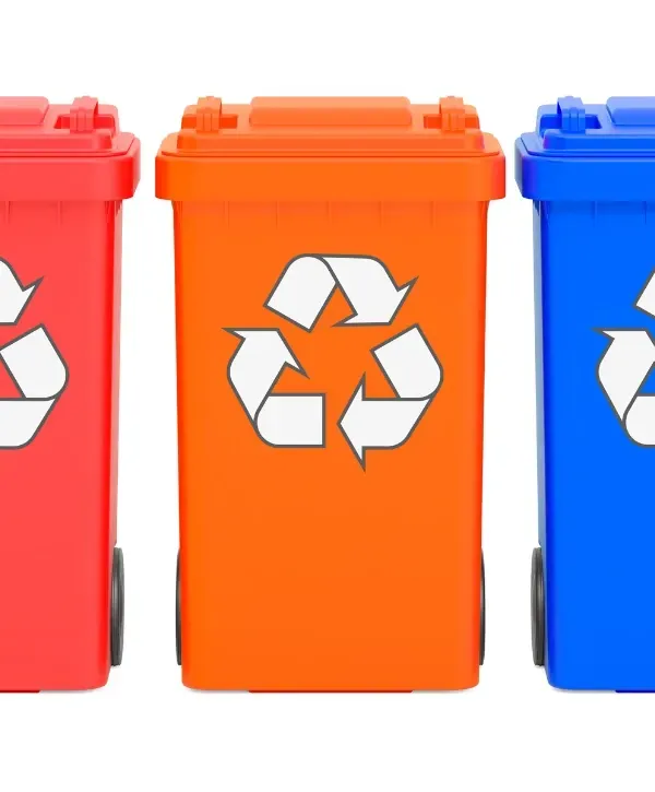 Blue and yellow recycling bins for sorting recyclable waste materials.