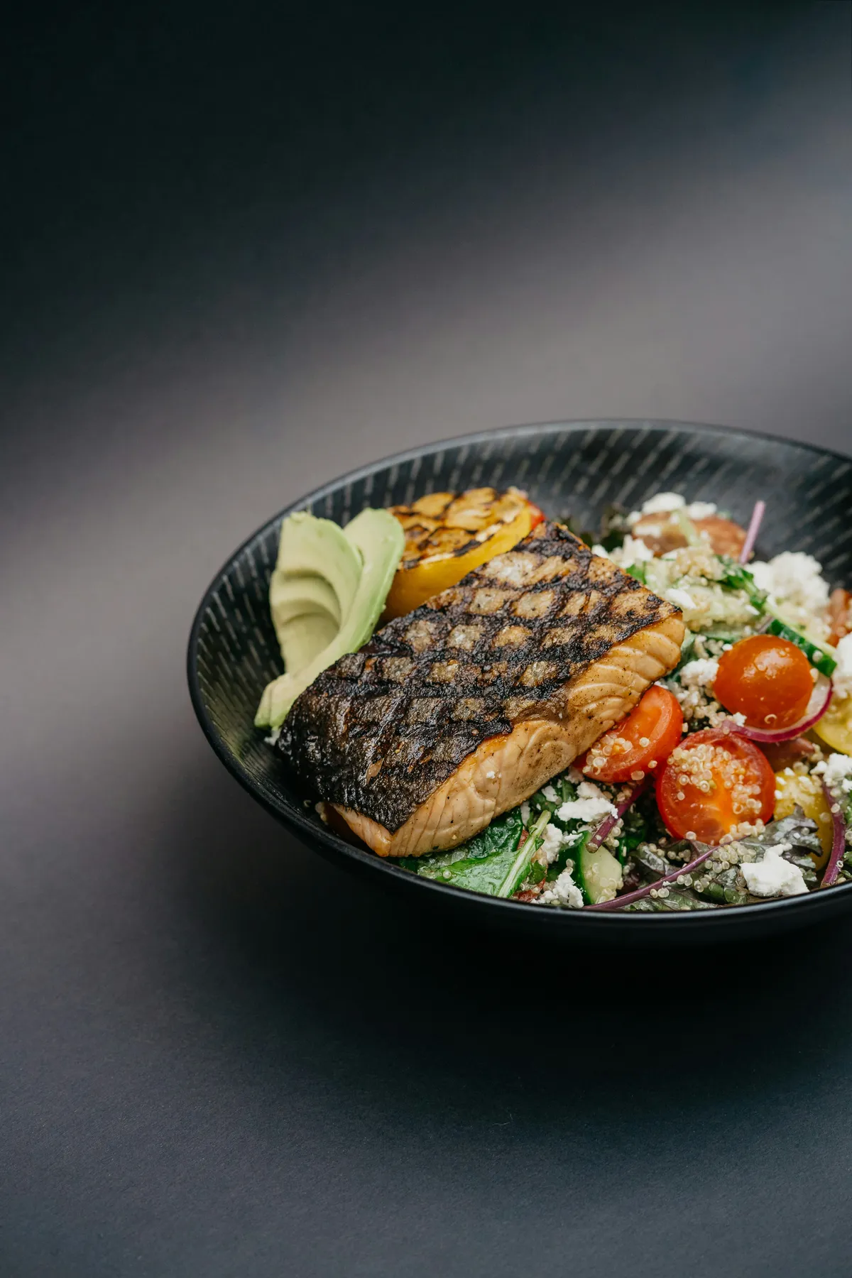 Grilled salmon bowl with vegetables and grain