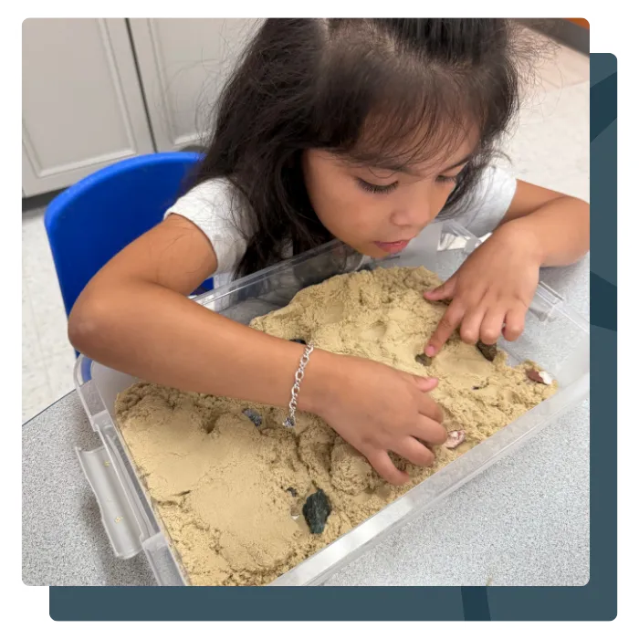 Child learning in preschool with book