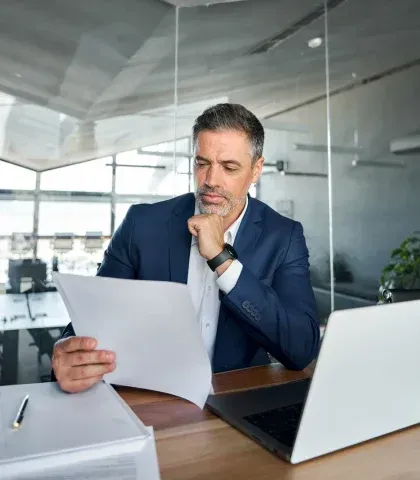 Senior employer reviewing workforce decisions for permanent recruitment planning