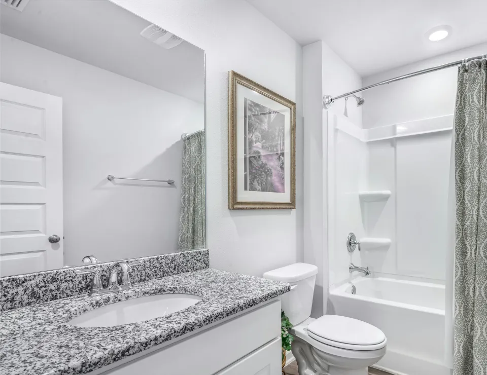 Professional handyman repairing kitchen cabinet in modern white kitchen providing expert home repair and maintenance services for homeowners in North Carolina