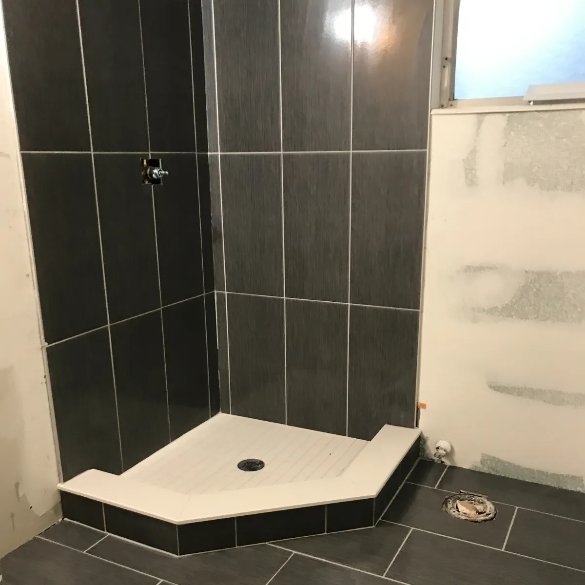 Elegant bathroom remodel with freestanding tub, large vanity, gold fixtures, and walk-in glass shower.