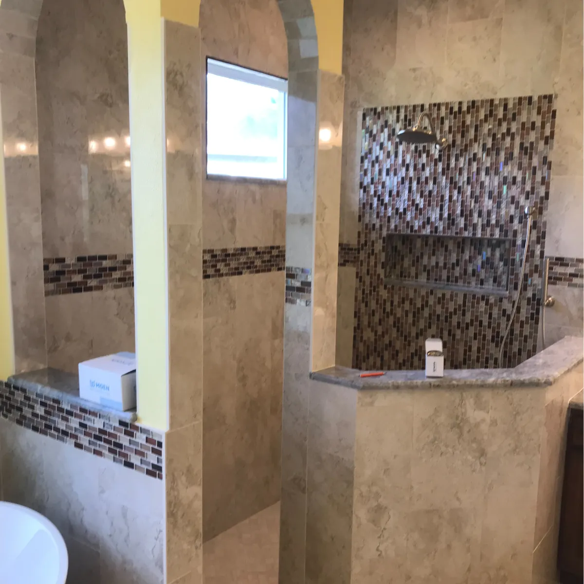 Elegant bathroom remodel with freestanding tub, large vanity, gold fixtures, and walk-in glass shower.