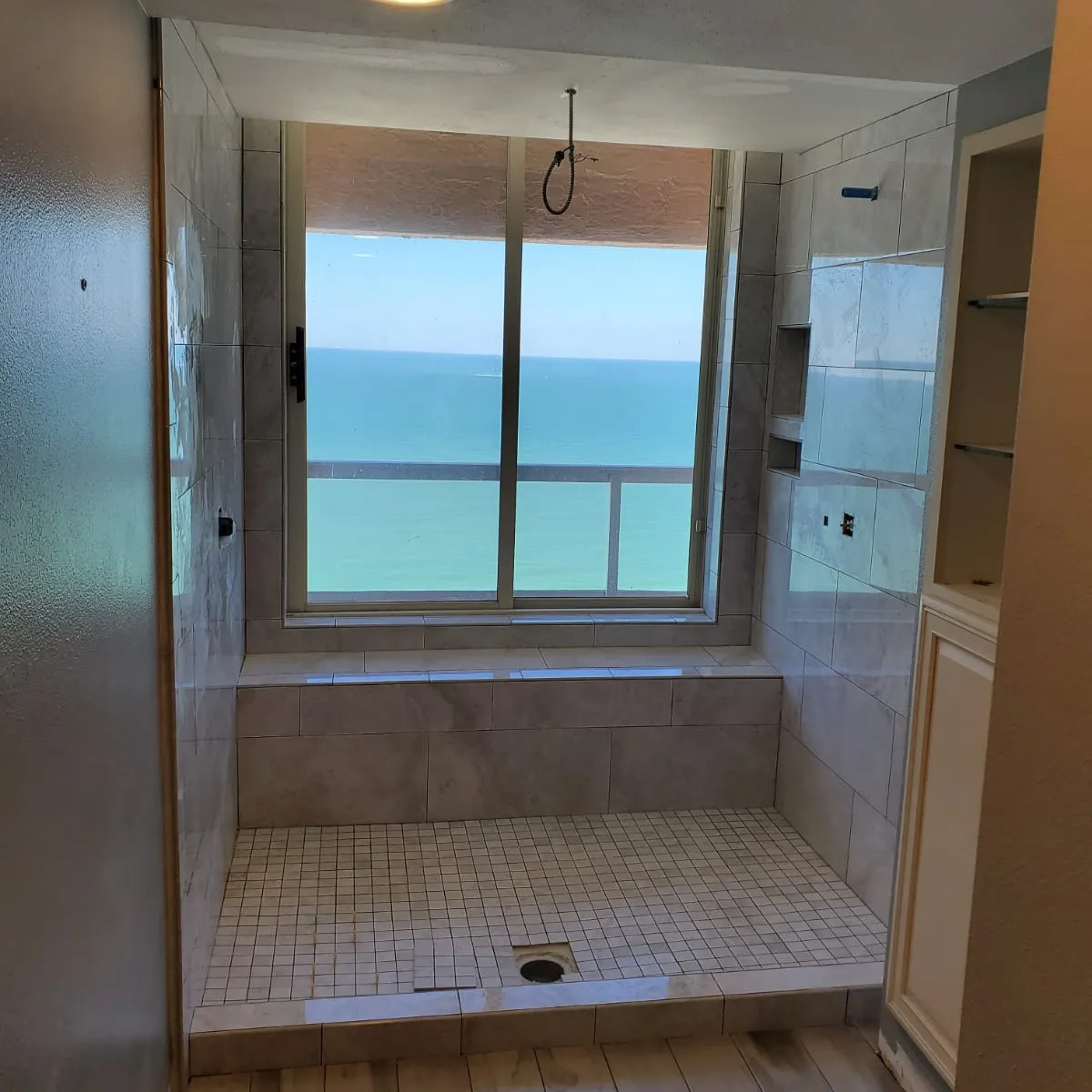 Elegant bathroom remodel with freestanding tub, large vanity, gold fixtures, and walk-in glass shower.
