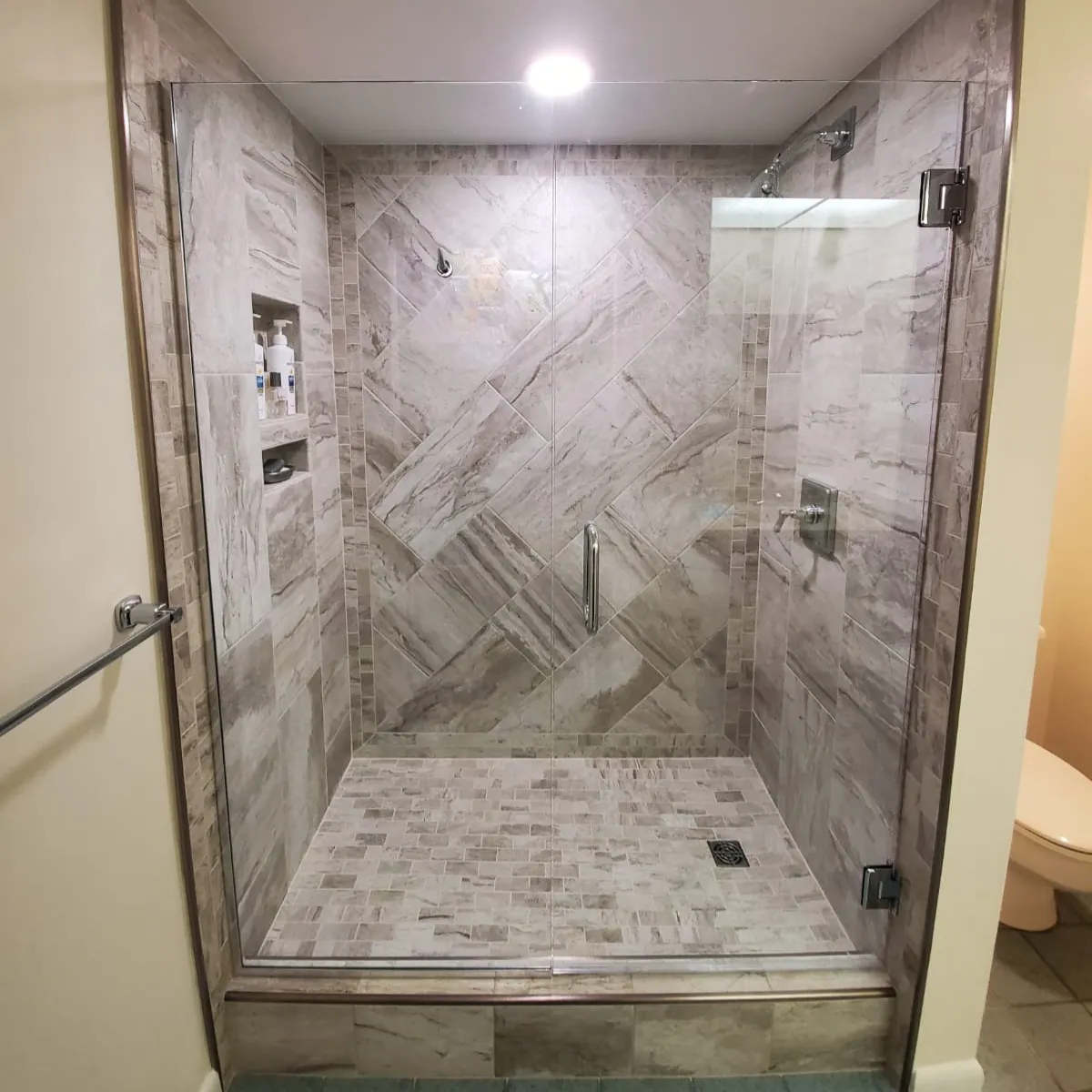 Elegant bathroom remodel with freestanding tub, large vanity, gold fixtures, and walk-in glass shower.