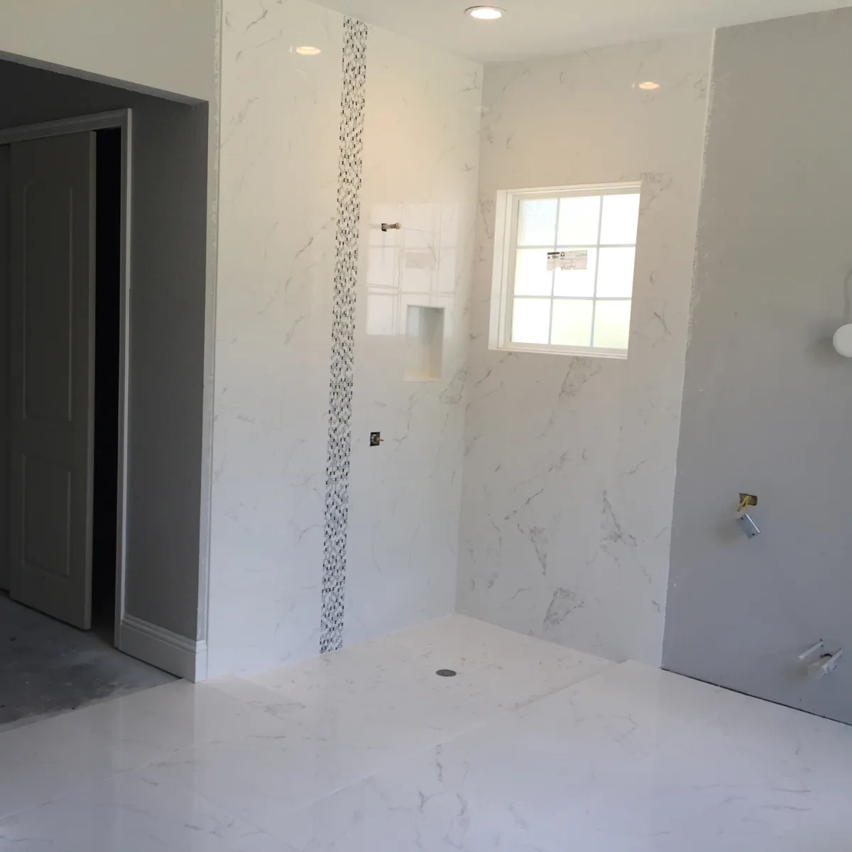 Luxury bathroom remodel with freestanding soaking tub walk in shower custom vanity and tile flooring completed by expert remodelers