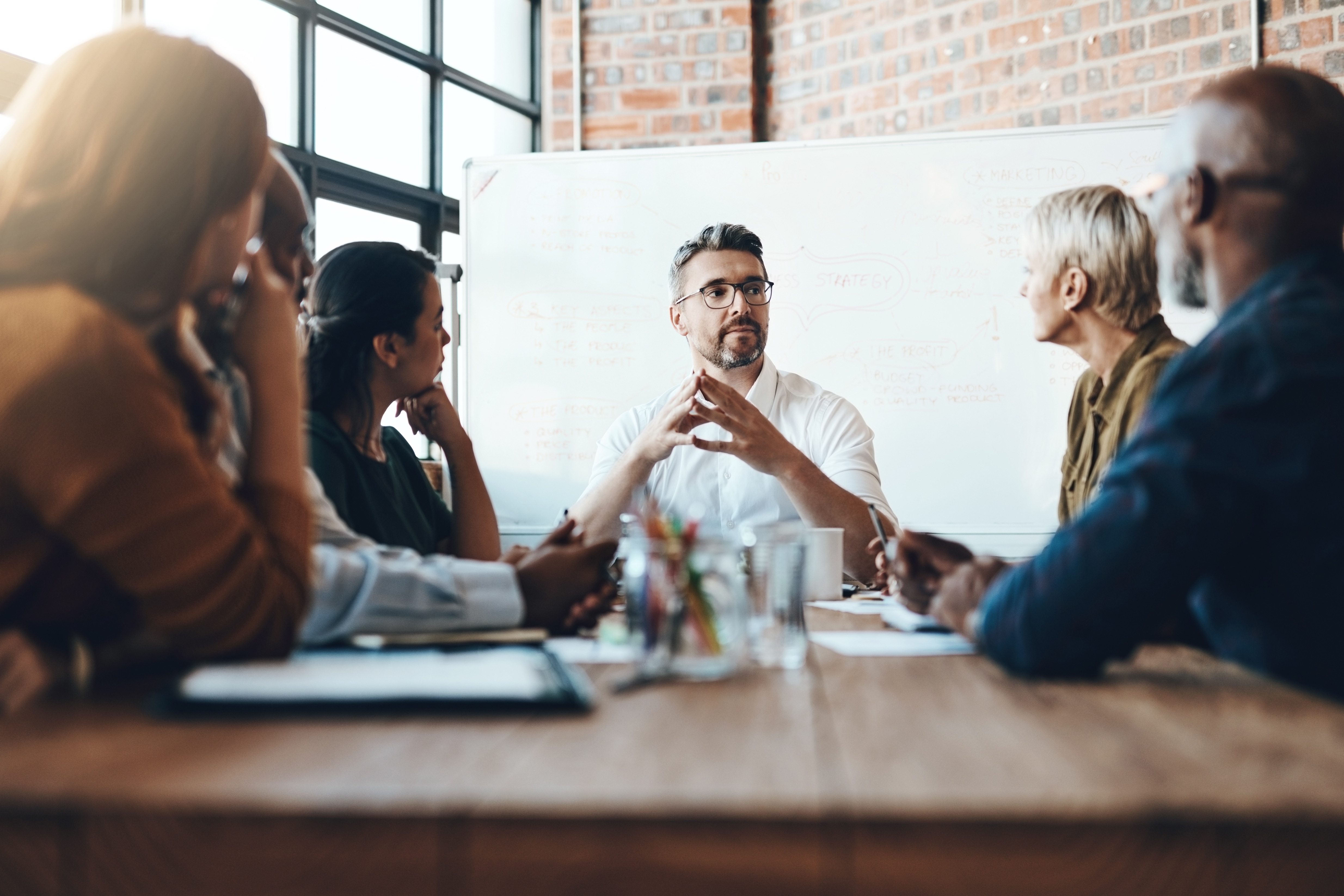 Evolve ActionCOACH executive coaching session with a leadership team in a boardroom meeting