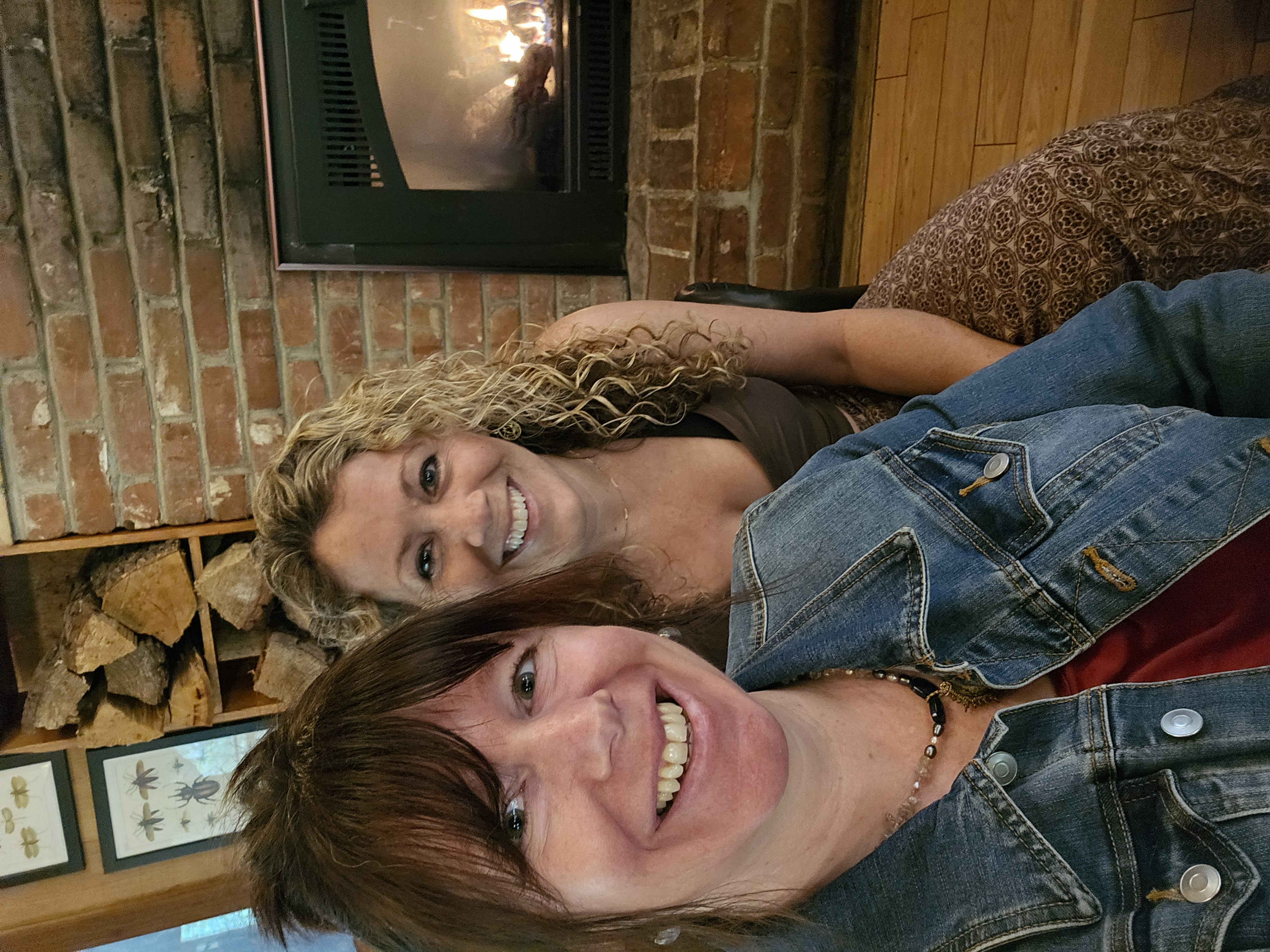 hosts Stephanie Gibson and Jena Baird by the cafe fire