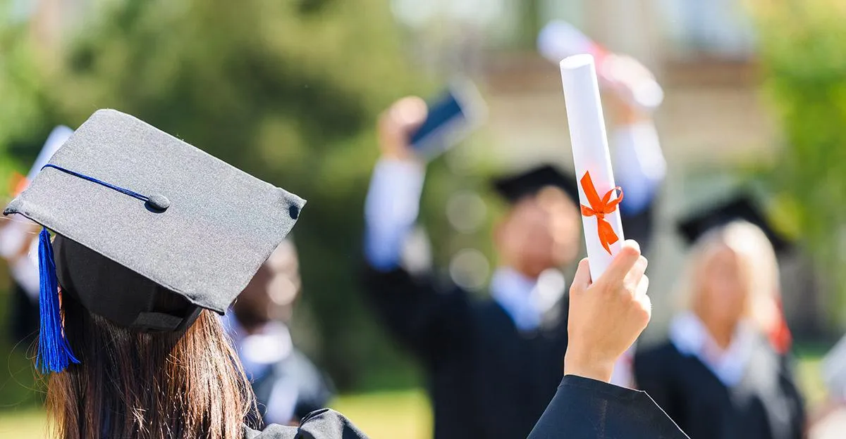 man in red shirt and brown shorts standing beside wall