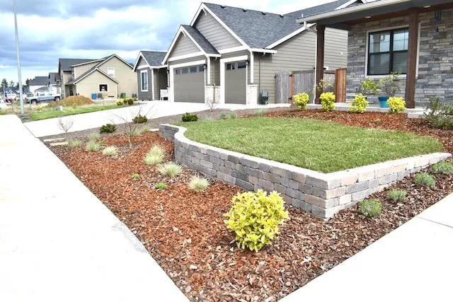house with retaining wall and front lawn