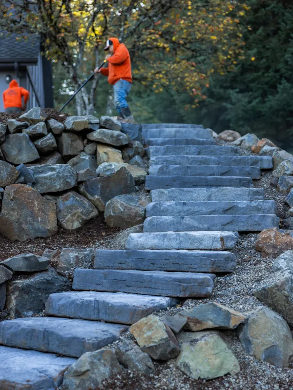 Close up of stone stairs with workers in the background