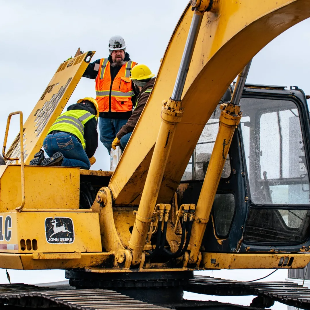North Country instructor and student on a full size excavator