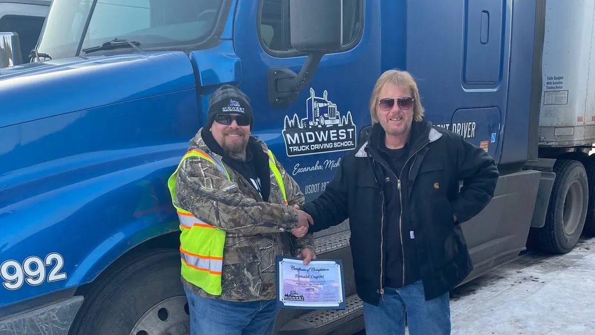 Midwest graduate receiving a certificate after the B to A upgrade