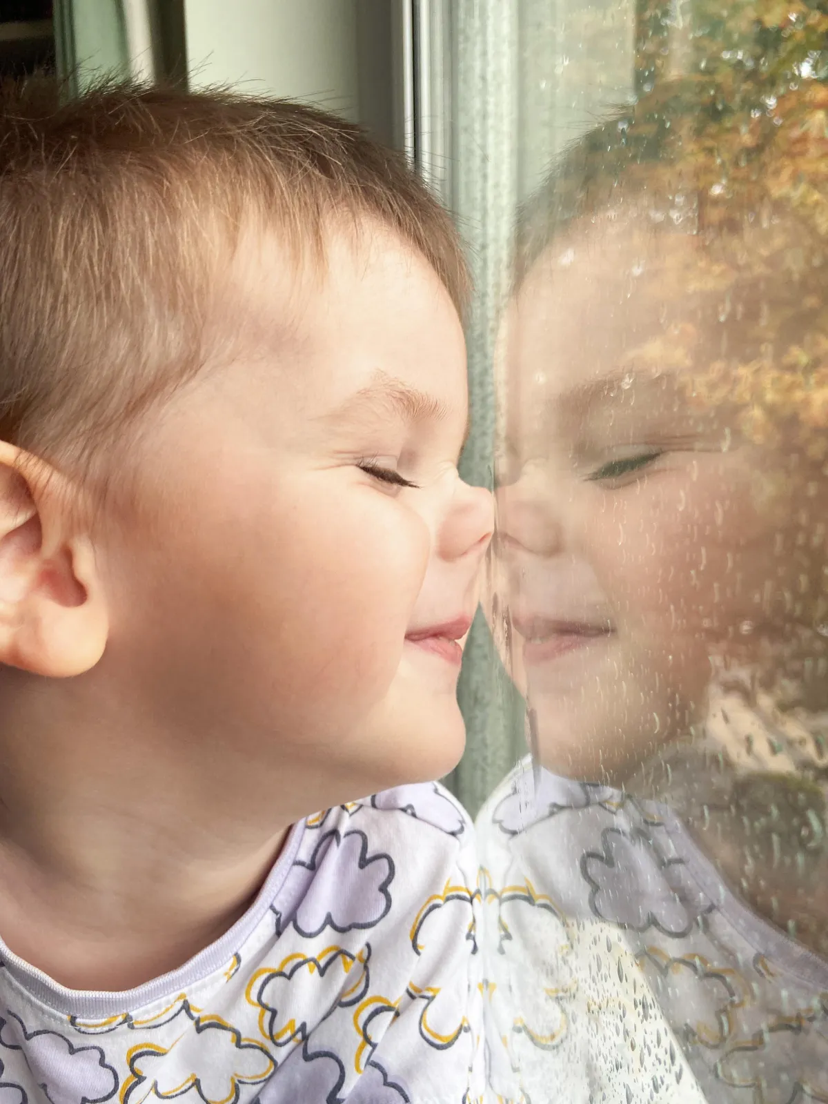 boy's poirtrait at the window and his reflection . mums photo academy