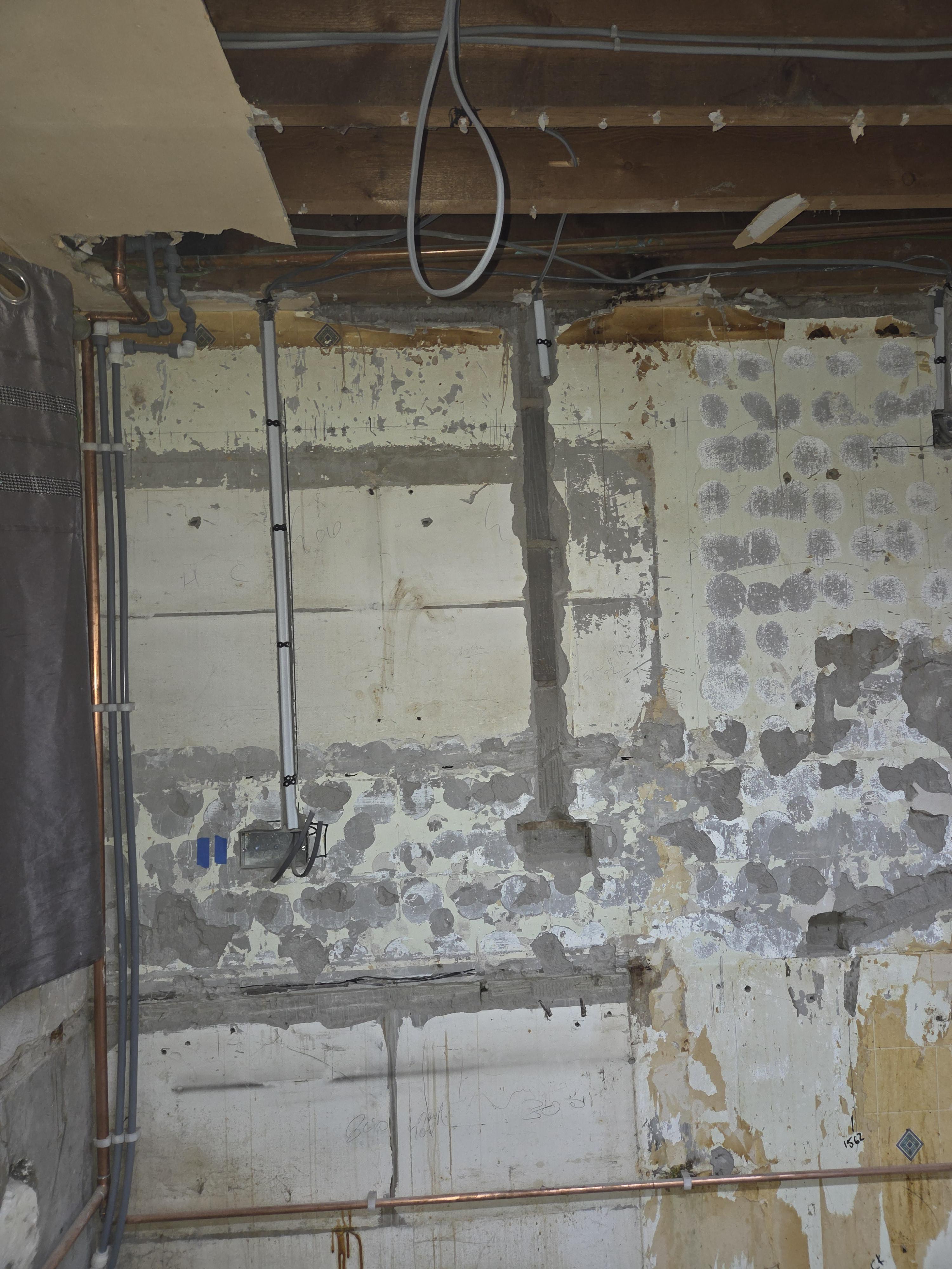 First-fix electrical rewiring in a Blackburn kitchen showing new conduits and cabling