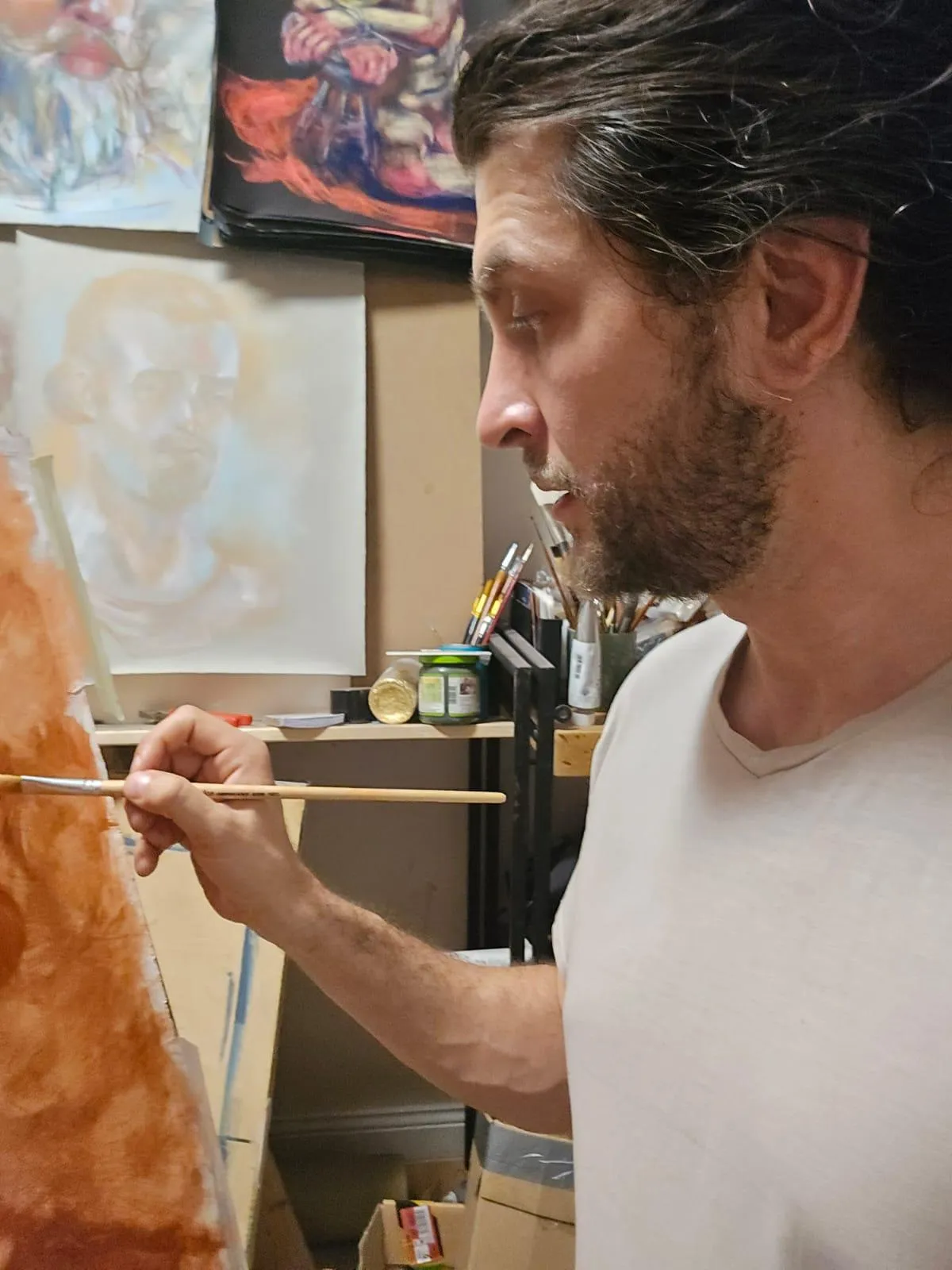 Black and white picture of Bogdan Jensen, the artist, painting a picture. 