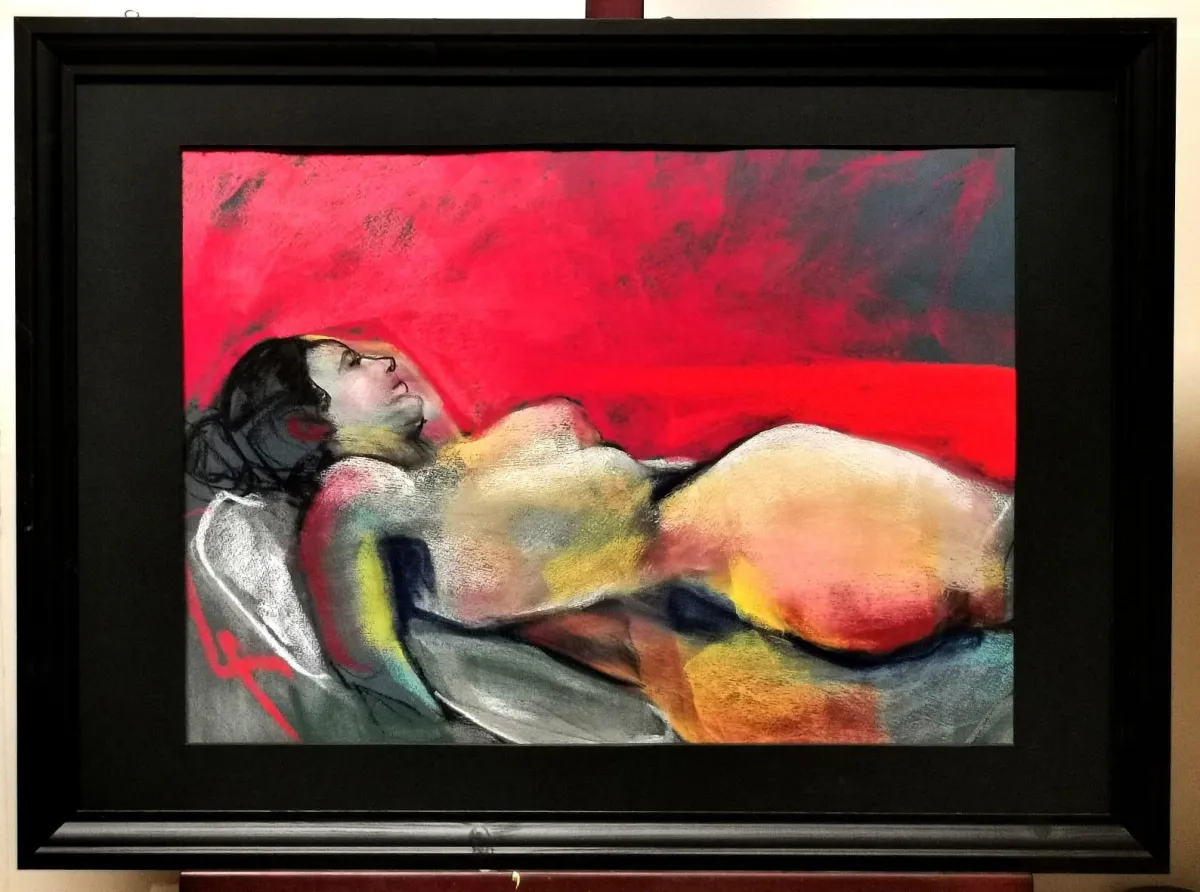 Soft Pastel of life model lying on a red firey blanket