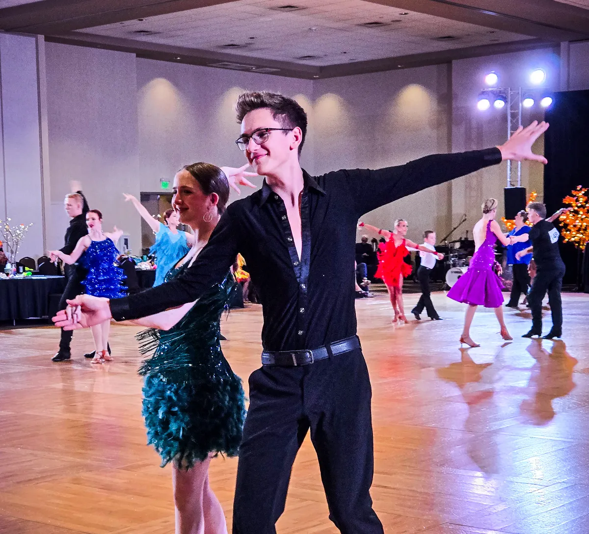 Phoenix Ballroom Academy student couple sharing a poised moment at a ballroom competition