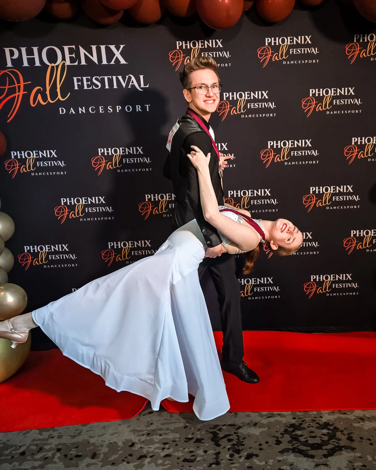 Ballroom dance couple posing together at a competition