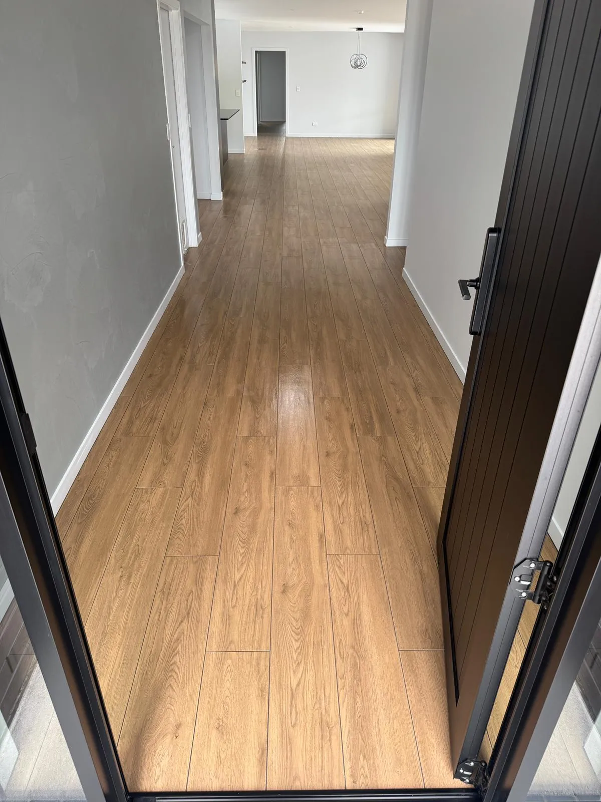 Hallway with timber look floor tiling installed in a residential new build by Remarkable Contracting in Hawke's Bay