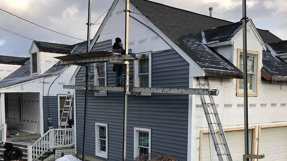 A house with new siding being installed.