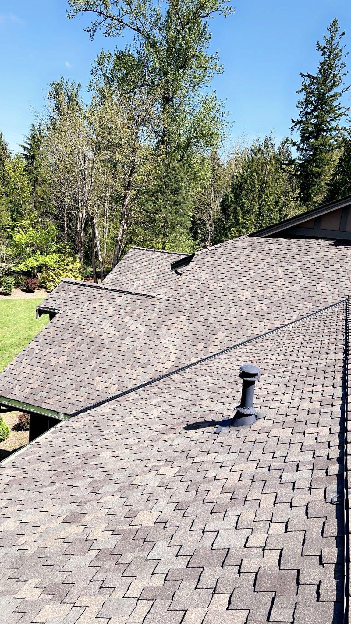 A roof with new asphalt shingles on it.