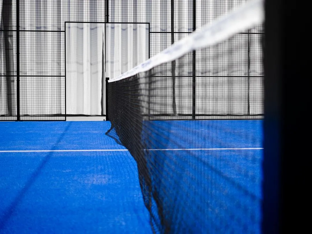 a tennis court with a crowd of people watching it