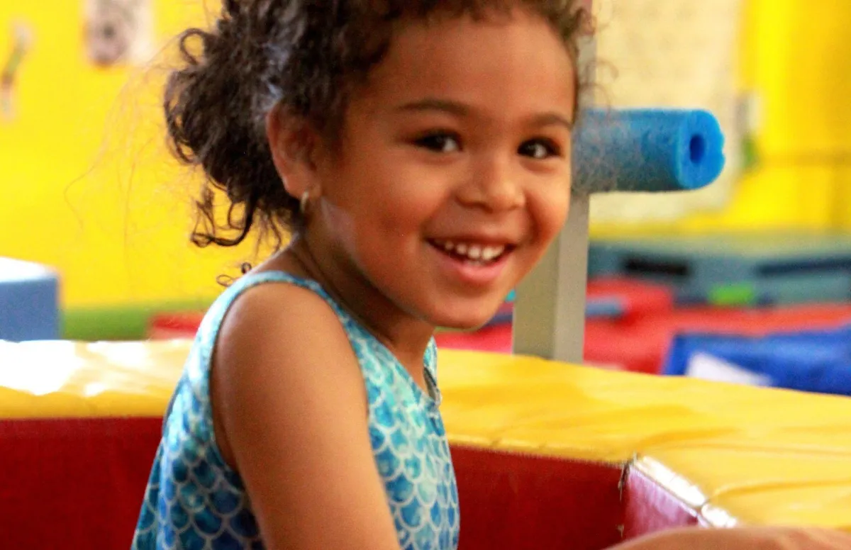 person wearing orange and gray Nike shoes walking on gray concrete stairs