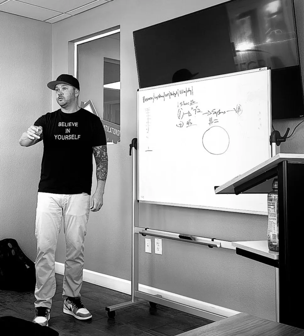 Jon Storey teaching at a whiteboard