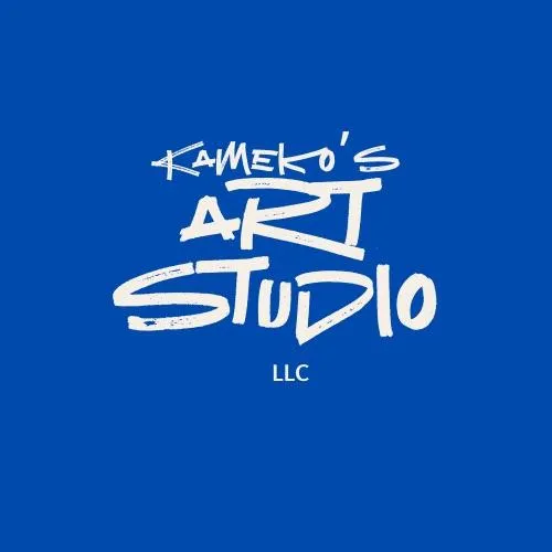 Kameko Rae painting in a sunlit studio, surrounded by vibrant canvases and art supplies. Her expression is focused and joyful, with natural light streaming through large windows, highlighting the creative atmosphere and her dedication to her craft.