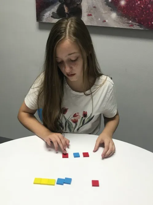 Dyslexic child completing a screening for auditory discrimination weakness.  Using the Barton Reading & Spelling tiles. 