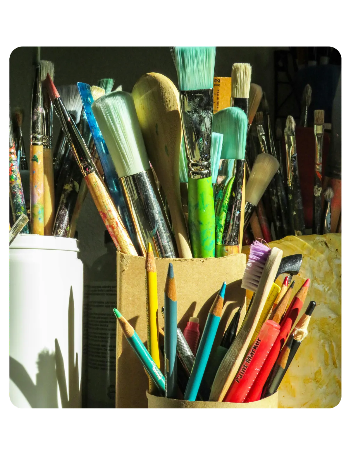 Mixed-media art journal and studio materials on a warm surface