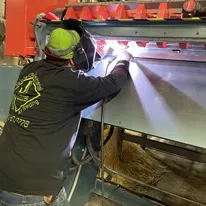 JI Industries - Welder welding on a tank