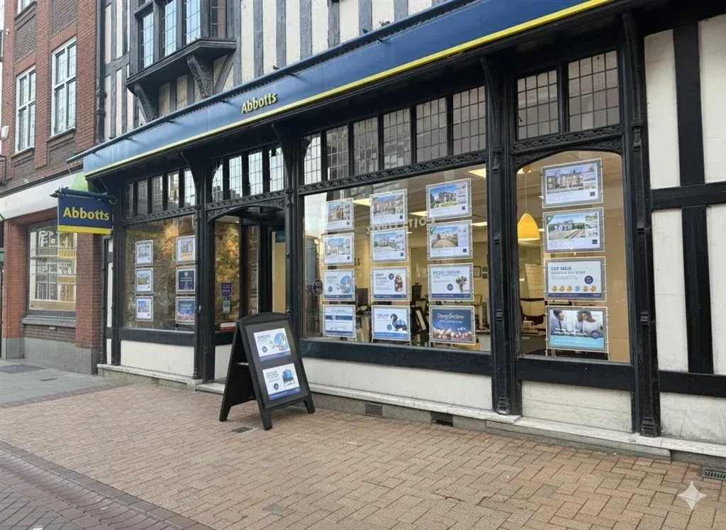 Modern co-working rooftop at golden hour with blurred city skyline in the background