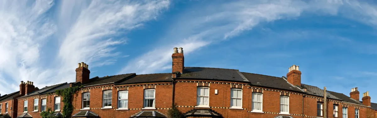 Modern co-working rooftop at golden hour with blurred city skyline in the background