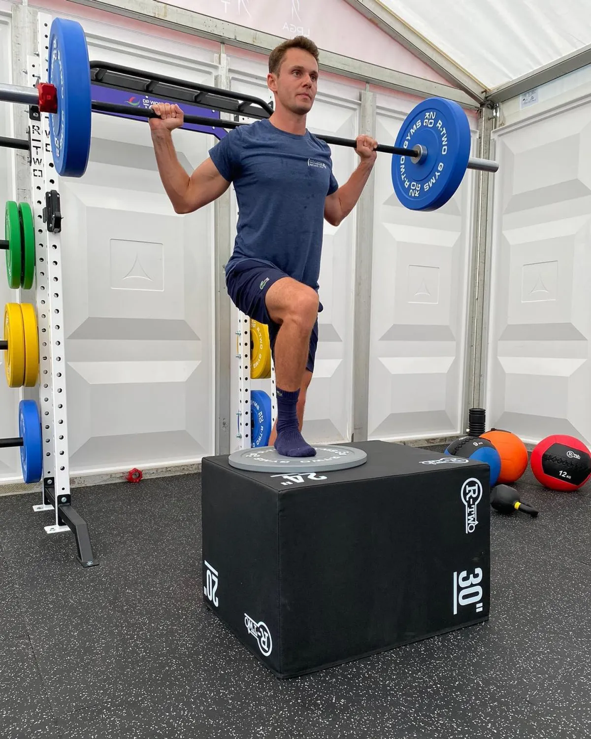 person standing beside black weights