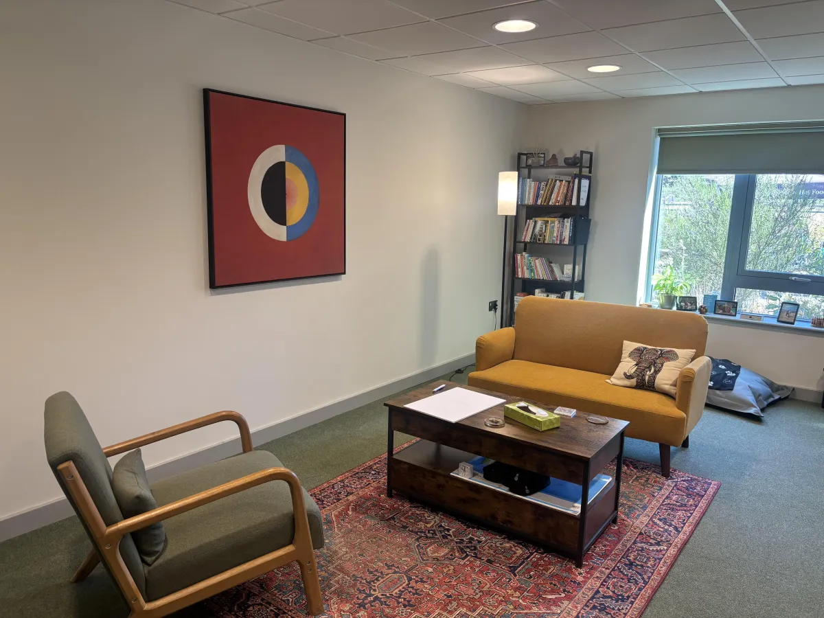 A warm, high-quality photograph of the comfortable coaching room.