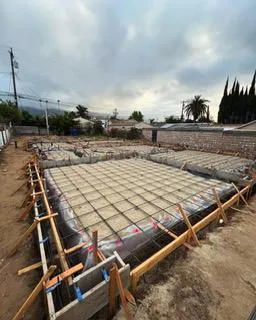 Image of a large footing installation before concrete has been poured, large square forms.