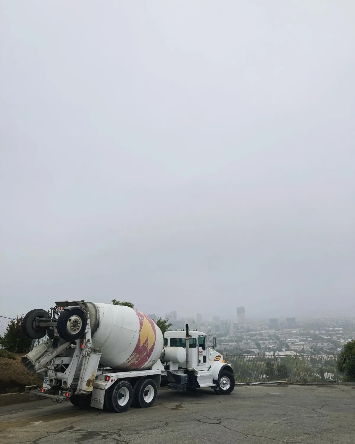 Image of Paco Ready Mix truck parked on the edge of a hillside street overlooking LA.