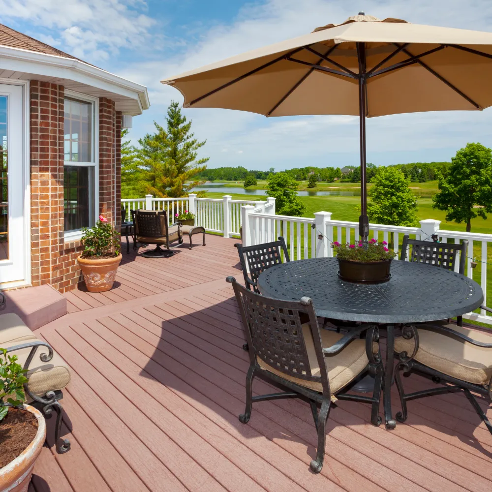 Outdoor living space in Logan Utah with custom deck, patio furniture, and backyard upgrade