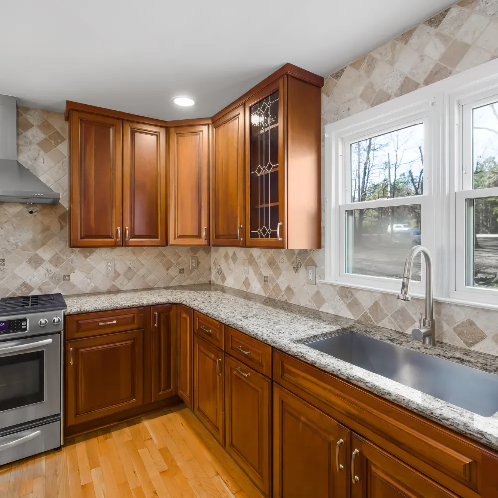 Custom kitchen remodeling in Logan Utah with modern cabinets, tile backsplash, and upgraded countertops